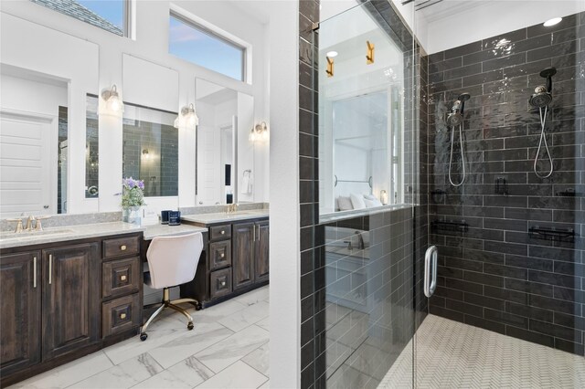 full bath with vanity, a high ceiling, a stall shower, and marble finish floor