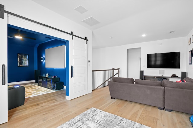 living room featuring visible vents, a barn door, wood finished floors, and recessed lighting