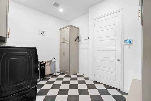 washroom featuring washer / clothes dryer, visible vents, cabinet space, dark floors, and recessed lighting