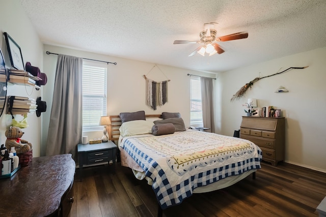 bedroom featuring a ceiling fan, a textured ceiling, multiple windows, and dark wood-type flooring