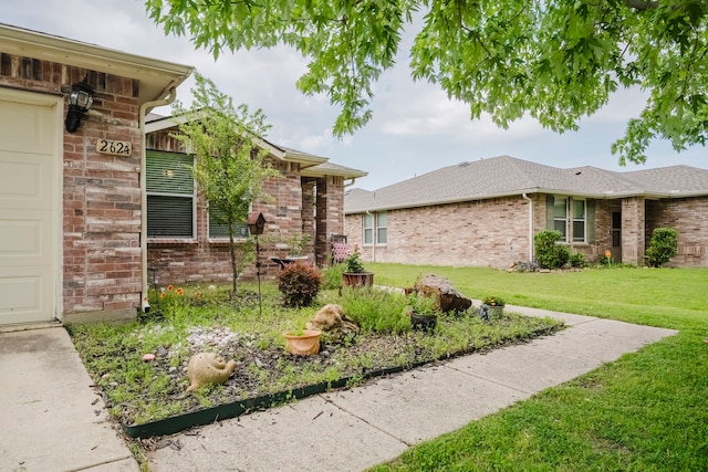 2624 Rockport Ln, Little Elm, TX 75068 - view of property exterior featuring a yard and brick siding