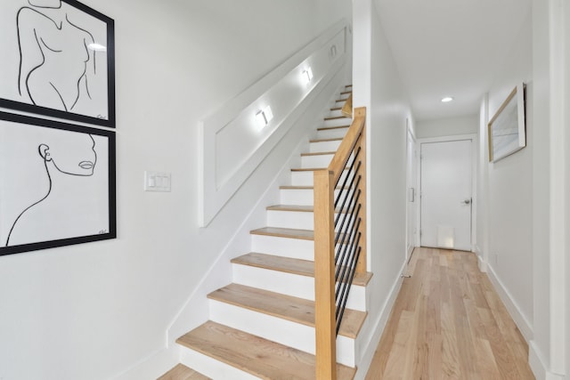 stairs with recessed lighting, baseboards, and wood finished floors