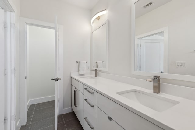 full bathroom with a sink, tile patterned floors, double vanity, and visible vents