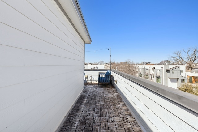 view of side of home with a residential view and a balcony