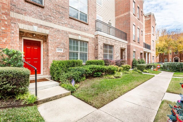 doorway to property featuring brick siding