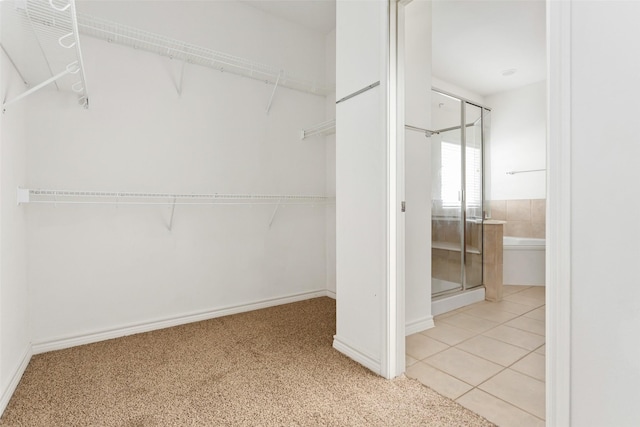 walk in closet with light tile patterned floors