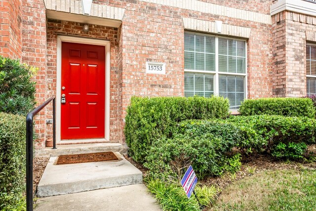 property entrance featuring brick siding
