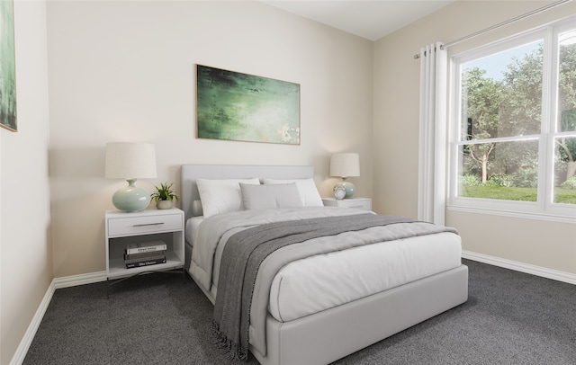 bedroom with baseboards and dark carpet