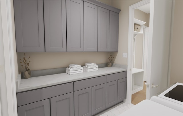 washroom featuring cabinet space and marble finish floor