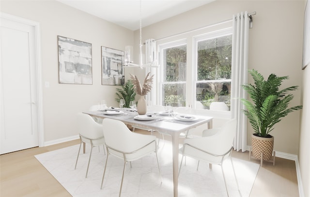 dining area featuring baseboards and light wood-type flooring