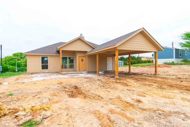3406 Woodlake Dr, Granbury, TX 76048 - ranch-style home featuring a shingled roof, a chimney, and a carport
