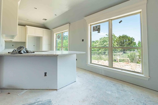 3406 Woodlake Dr, Granbury, TX 76048 - kitchen with light countertops, a peninsula, white cabinets, and vaulted ceiling