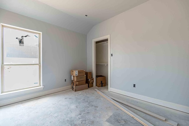 3406 Woodlake Dr, Granbury, TX 76048 - spare room featuring concrete flooring, baseboards, and vaulted ceiling