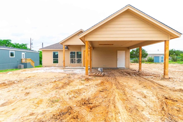 3406 Woodlake Dr, Granbury, TX 76048 - rear view of property featuring a carport and cooling unit