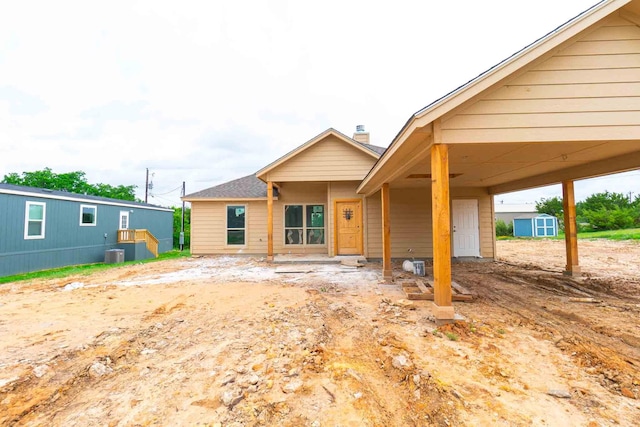 3406 Woodlake Dr, Granbury, TX 76048 - rear view of property featuring an outbuilding, a storage shed, and central AC unit