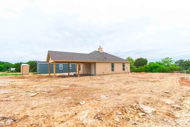 3406 Woodlake Dr, Granbury, TX 76048 - rear view of property with a chimney