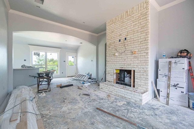 3406 Woodlake Dr, Granbury, TX 76048 - living area with arched walkways, ornamental molding, and a fireplace