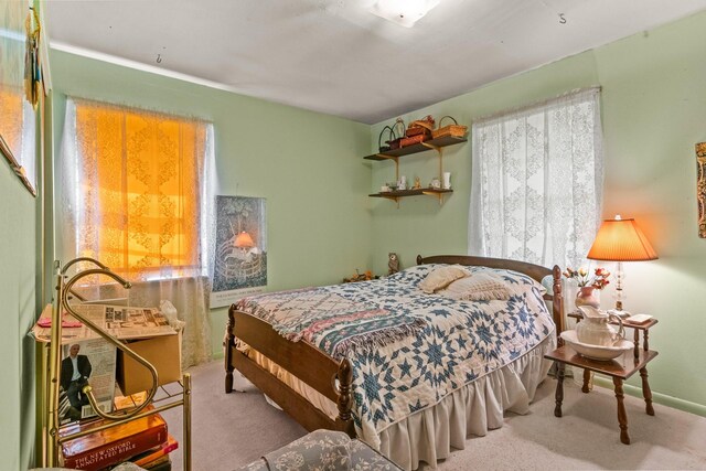 carpeted bedroom featuring baseboards