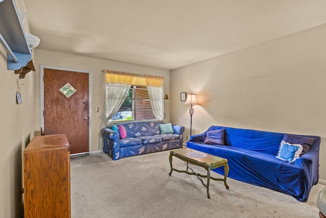 living area featuring carpet flooring and baseboards