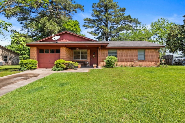 ranch-style home featuring a garage, concrete driveway, a front yard, and brick siding