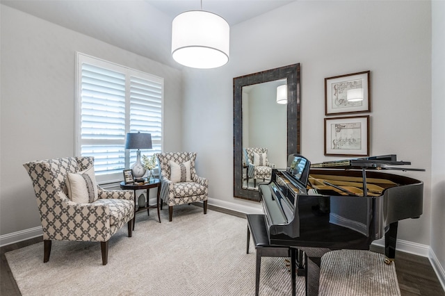 living area featuring baseboards and wood finished floors