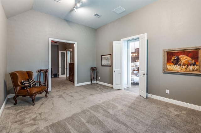interior space featuring carpet flooring, high vaulted ceiling, visible vents, and baseboards