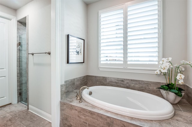 full bathroom with a shower stall and a garden tub