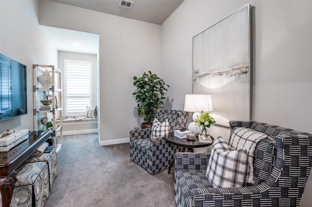 living room featuring baseboards, carpet, and visible vents