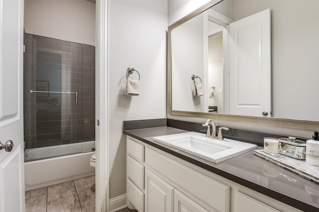 full bathroom with vanity, combined bath / shower with glass door, and toilet