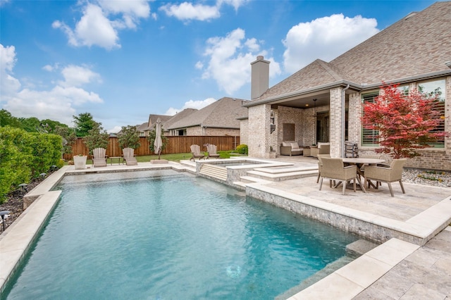 view of pool featuring a patio, a fenced backyard, outdoor lounge area, and a pool with connected hot tub