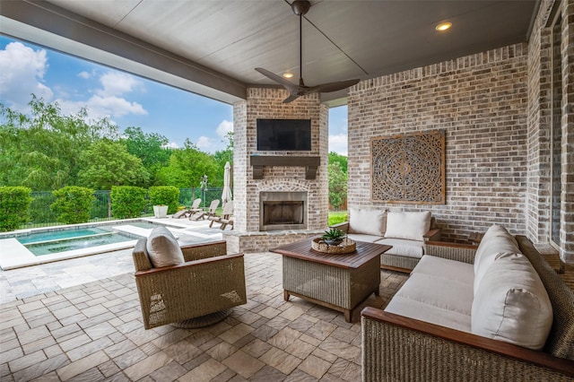 view of patio featuring fence, a pool, a ceiling fan, an outdoor living space with a fireplace, and an in ground hot tub