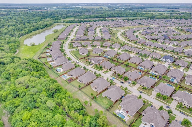birds eye view of property featuring a water view and a residential view