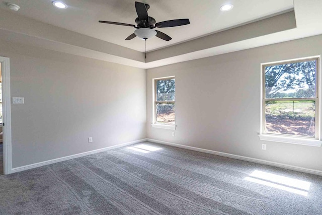 carpeted spare room featuring a tray ceiling, baseboards, a ceiling fan, and recessed lighting