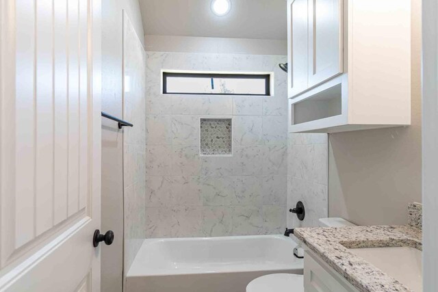 full bathroom with shower / bath combination, vanity, and toilet