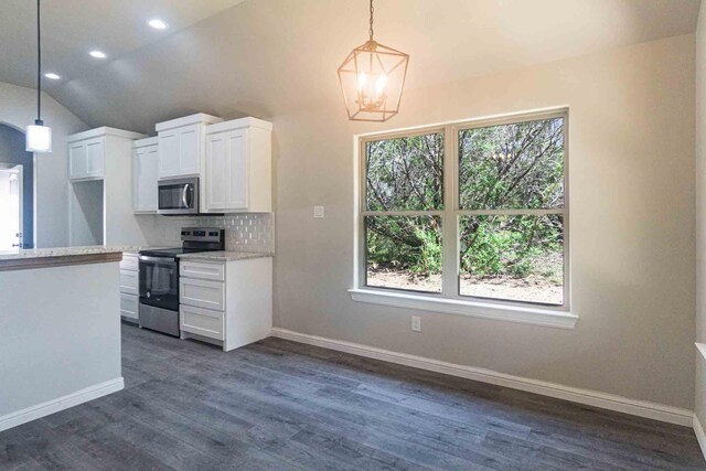 kitchen featuring decorative backsplash, white cabinets, lofted ceiling, an inviting chandelier, and stainless steel appliances