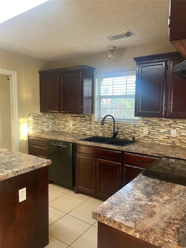 kitchen with light tile patterned floors, decorative backsplash, visible vents, and dishwasher