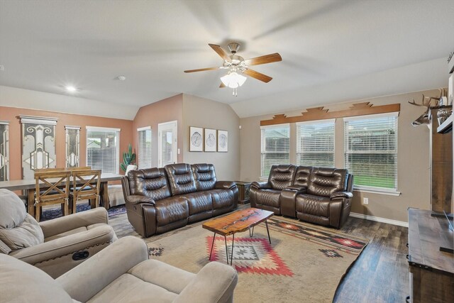 living room featuring baseboards, lofted ceiling, wood finished floors, and ceiling fan