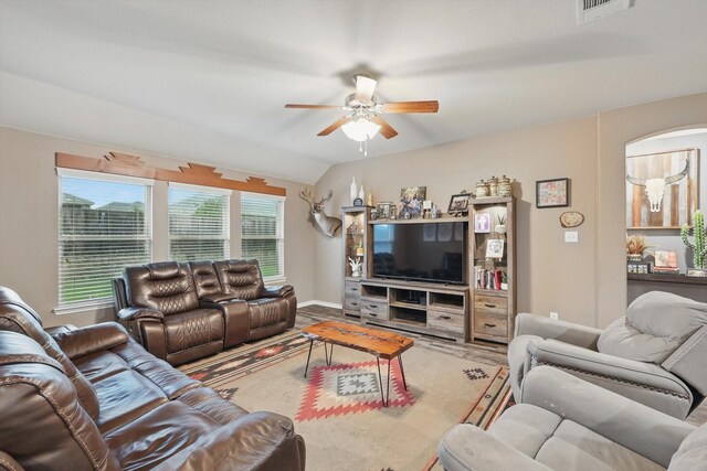 living room featuring visible vents, a ceiling fan, and vaulted ceiling