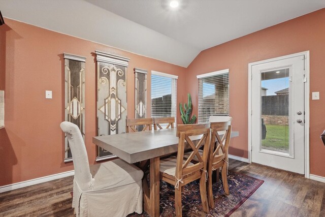 dining space featuring baseboards, vaulted ceiling, and dark wood-style floors