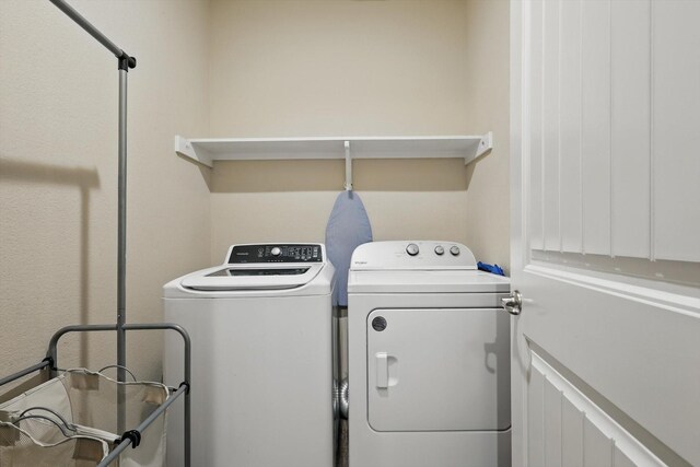 washroom featuring separate washer and dryer and laundry area