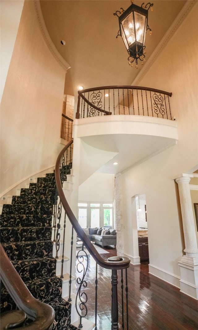 320 Hines Xing, Bullard, TX 75757 - stairway with baseboards, a towering ceiling, wood finished floors, and an inviting chandelier