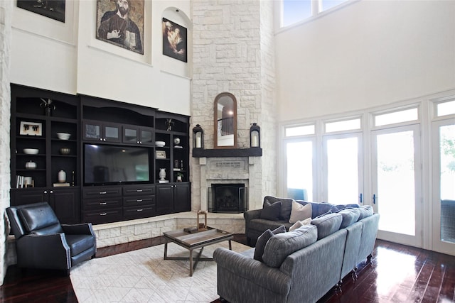 320 Hines Xing, Bullard, TX 75757 - living area with a stone fireplace, hardwood / wood-style flooring, and a towering ceiling