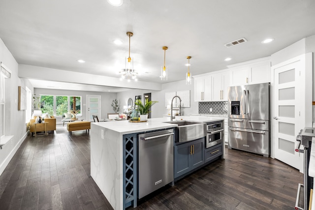 8911 Diceman Dr, Dallas, TX 75218 - kitchen with visible vents, a sink, open floor plan, stainless steel appliances, and recessed lighting