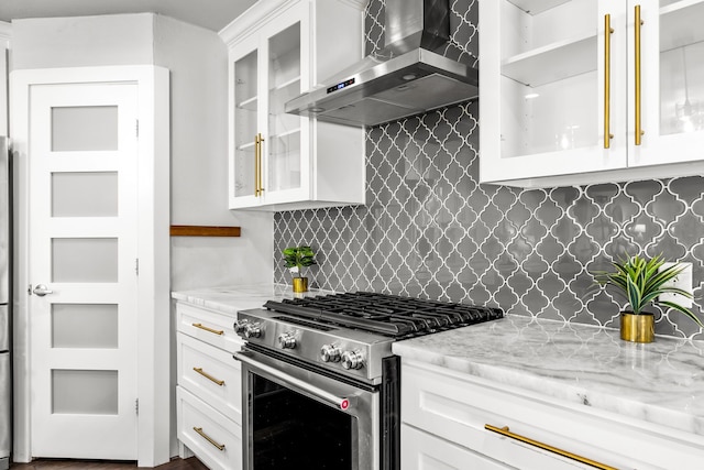 8911 Diceman Dr, Dallas, TX 75218 - kitchen featuring light stone countertops, stainless steel gas range, wall chimney exhaust hood, white cabinets, and backsplash