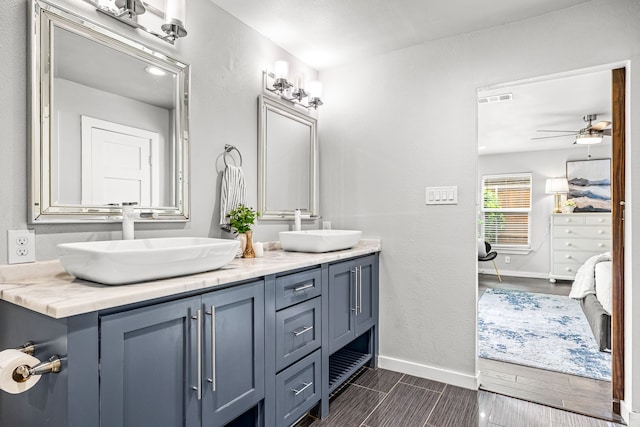 8911 Diceman Dr, Dallas, TX 75218 - ensuite bathroom with visible vents, a sink, baseboards, and ensuite bath