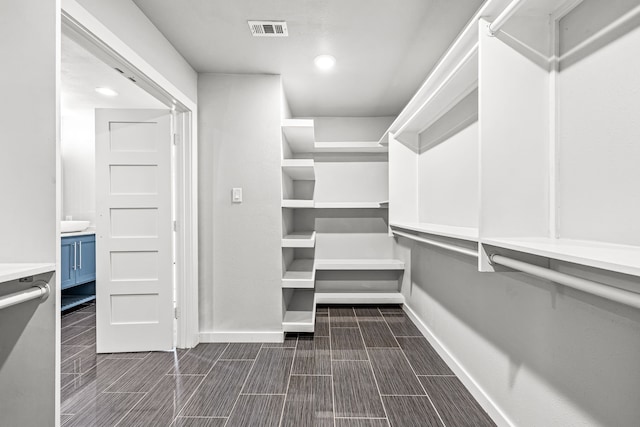 8911 Diceman Dr, Dallas, TX 75218 - walk in closet with wood tiled floor and visible vents