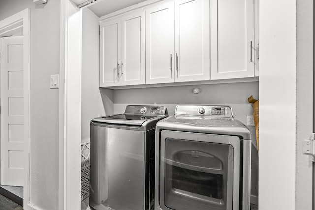8911 Diceman Dr, Dallas, TX 75218 - laundry area featuring washer and clothes dryer and cabinet space