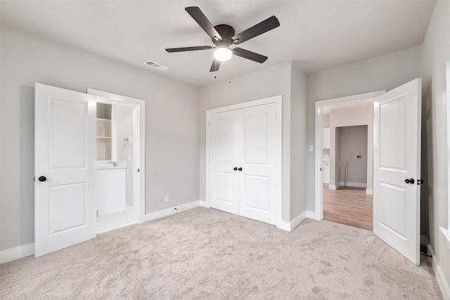 unfurnished bedroom featuring baseboards, carpet, a closet, and visible vents