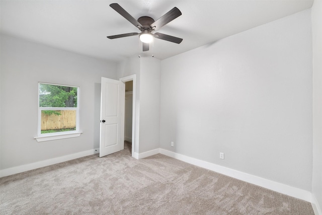 unfurnished bedroom with baseboards, a ceiling fan, and carpet