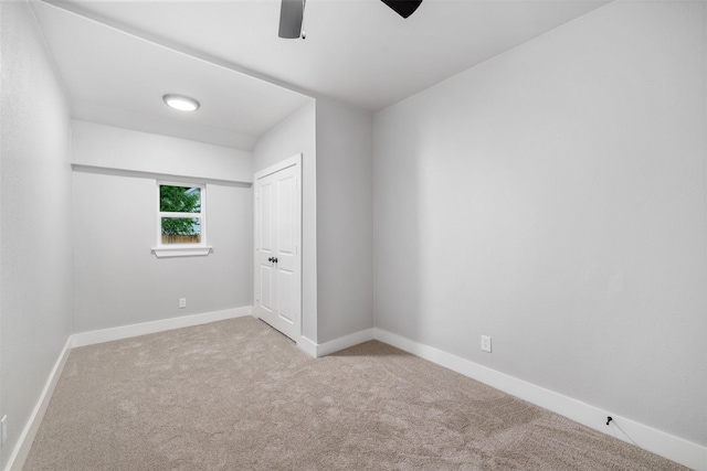 unfurnished bedroom with a closet, carpet, ceiling fan, and baseboards